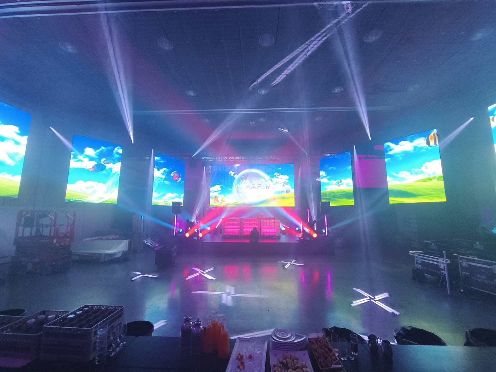 LED screen wall and moving-head lighting rig at a live event