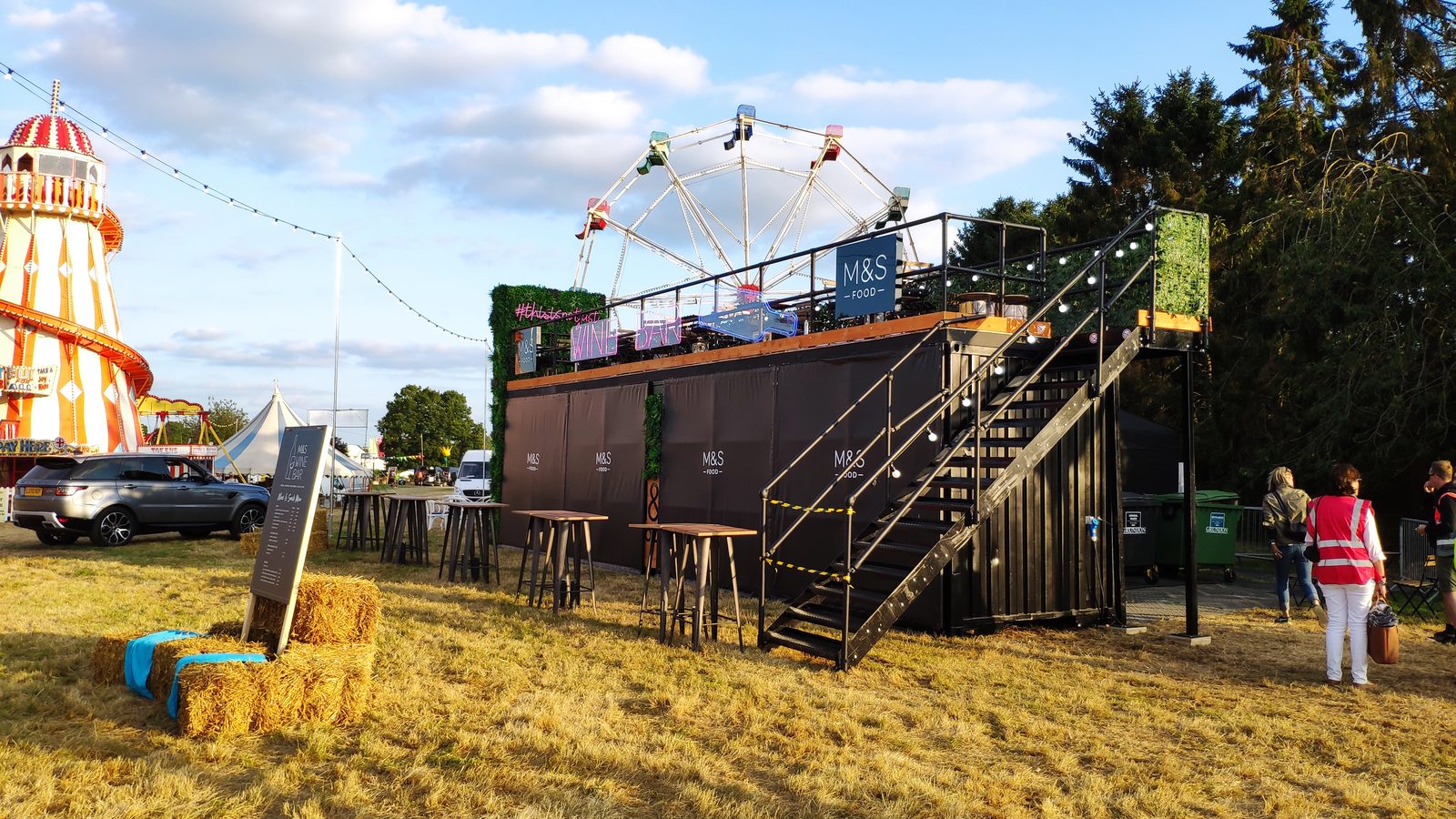 Festival bar structure with rooftop wine bar and Ferris wheel