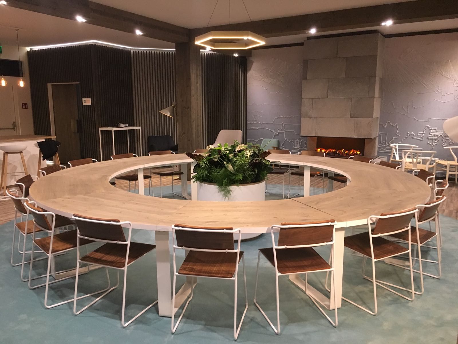 Circular conference lounge setup with fireplace