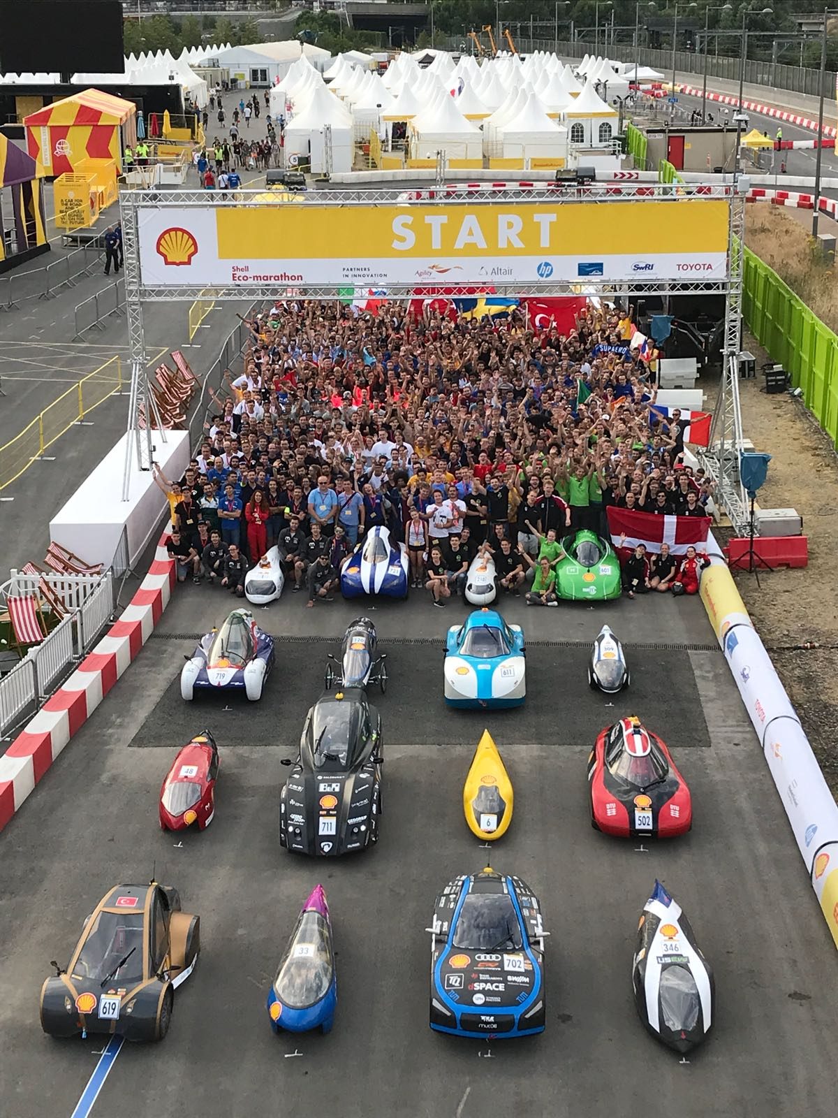 Large-scale outdoor motorsport event with crowd and vehicles