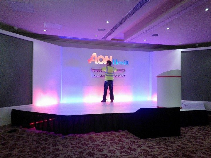 Corporate conference stage build with branded lighting